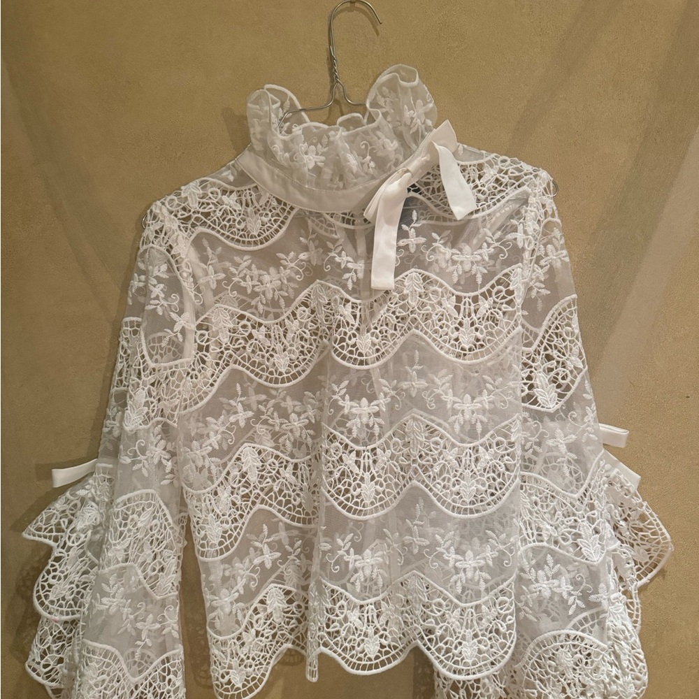 Gracia small mock neck lace over shirt. Beautiful detail of lace and trim bows.
